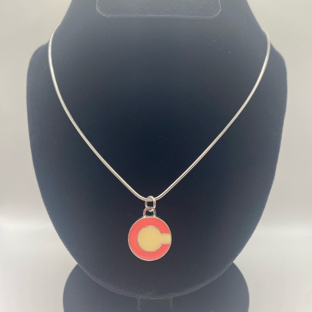 Coach charm on a necklace.